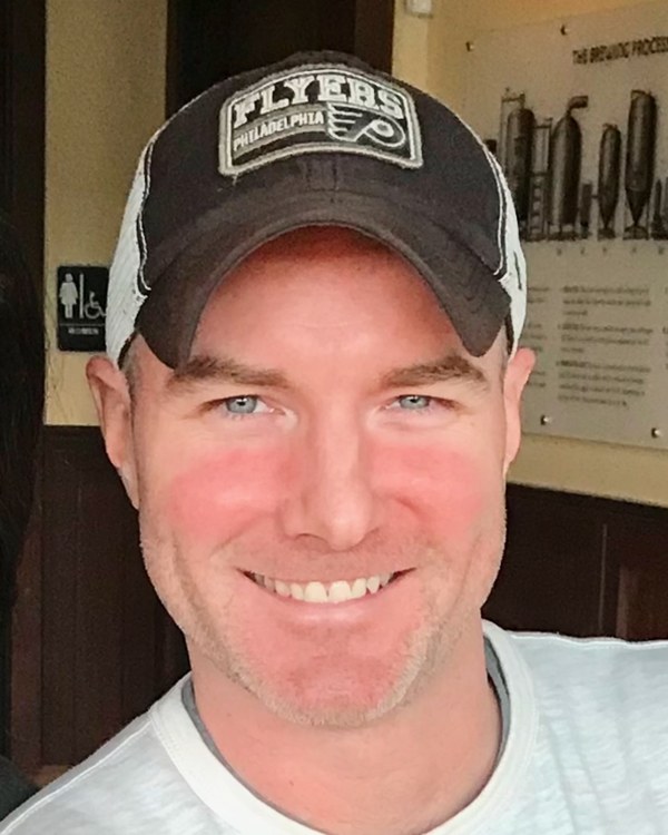 Mike Platt, author of A Cold Night In February, wearing a Philadelphia sports cap and t-shirt